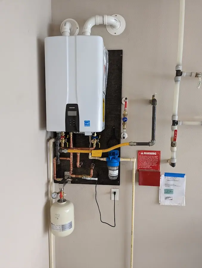 Professional plumber installing copper piping in a Topsfield home